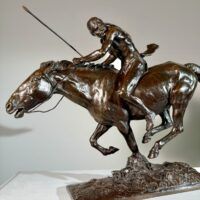 Alt text: Bronze sculpture of a Native American man on horseback