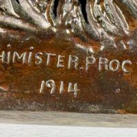 Alt text: Bronze sculpture, signature detail