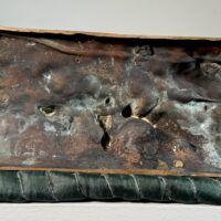 Alt text: Bronze sculpture, underside detail