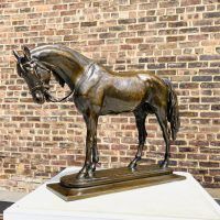 Alt text: Bronze sculpture of an Arabian horse with head slightly lowered, angled view