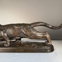 Alt text: Bronze sculpture of a prowling mountain lion