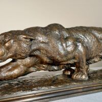 Alt text: Bronze sculpture of a prowling mountain lion