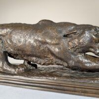Alt text: Bronze sculpture of a prowling mountain lion