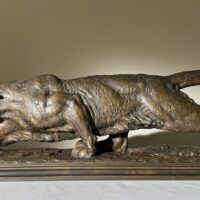Alt text: Bronze sculpture of a prowling mountain lion