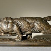 Alt text: Bronze sculpture of a prowling mountain lion