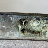 Alt text: Bronze sculpture, underside detail