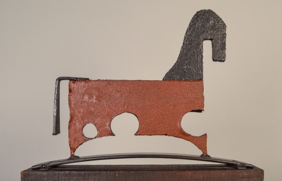 Alt text: Painted, welded steel sculpture of a horse, side view