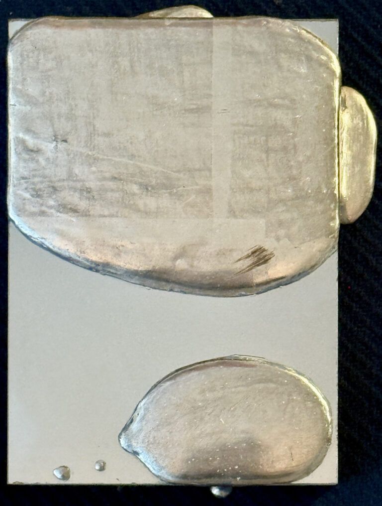 Alt text: Mixed media artwork with silver