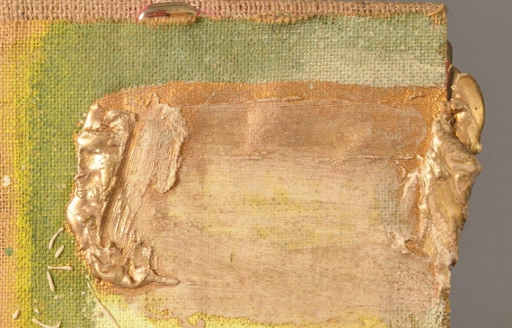 Alt text: Abstract paint and gilt patterns on burlap mounted to a wood board, angled view