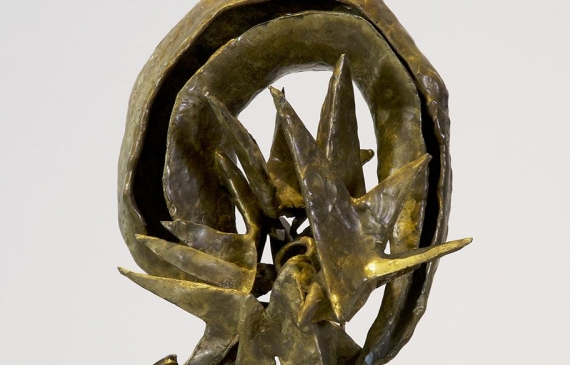 Alt text: Abstracted bronze sculpture with rounded top on a marble base