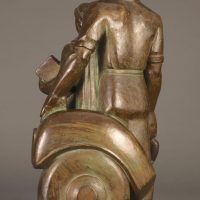 Alt text: Bronze sculpture of a family with father, mother, and child, rear view