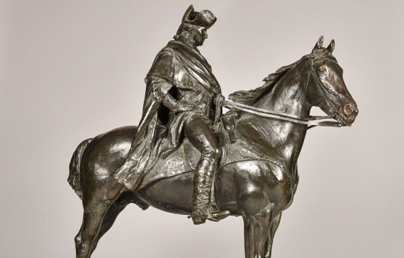 Alt text: Bronze sculpture of George Washington sitting atop his horse, angled view