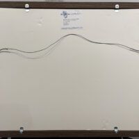 Alt text: Framed painting verso