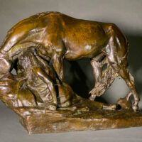 Alt text: Bronze sculpture of a horse bending down alongside a girl sitting near to the ground, peering over a cliff