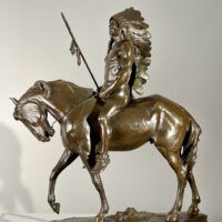 Alt text: Bronze sculpture of a Native American man on a horse