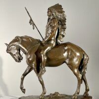 Alt text: Bronze sculpture of a Native American man on a horse