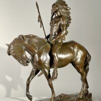 Alt text: Bronze sculpture of a Native American man on a horse