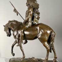 Alt text: Bronze sculpture of a Native American man on a horse