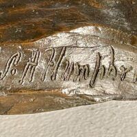 Alt text: Bronze sculpture, signature detail