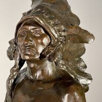 Alt text: Bronze sculpture of a Native American man