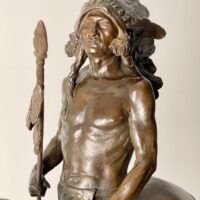 Alt text: Bronze sculpture of a Native American man