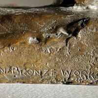 Alt text: Bronze sculpture, foundry mark