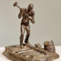 Alt text: Bronze sculpture of a railroad worker