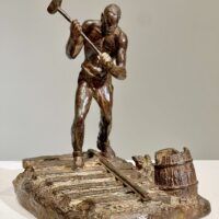 Alt text: Bronze sculpture of a railroad worker