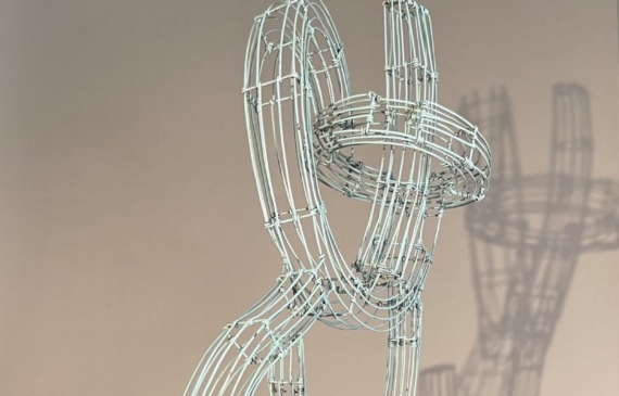 Alt text: Abstract wire sculpture of a musician
