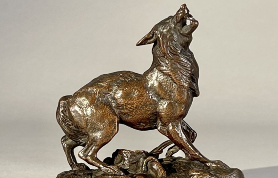 Alt text: Bronze sculpture of a wolf caught in a trap