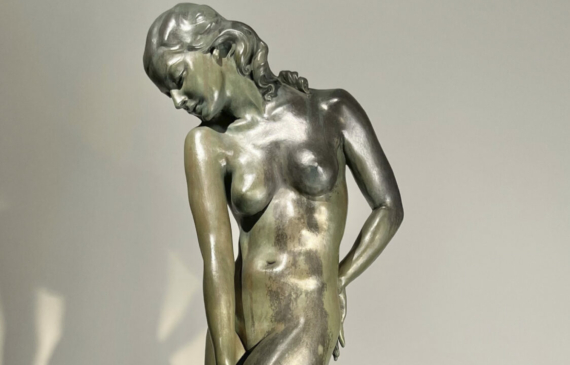 Alt text: Bronze sculpture of a nude female