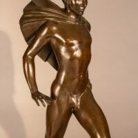 Alt text: Bronze sculpture of a male figure