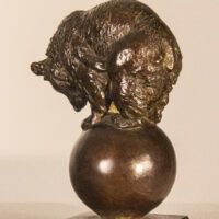 Alt text: Bronze sculpture of a bear balanced on a ball