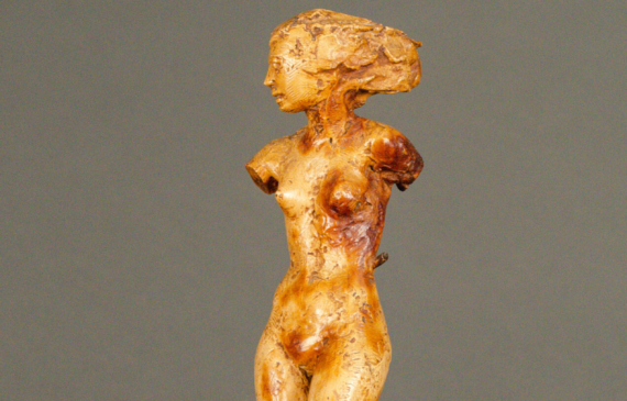 Alt text: Plaster sculpture of a woman on a shell