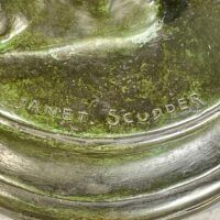 Alt text: Bronze sculpture base, signature detail