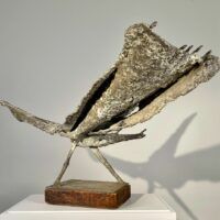 Alt text: Abstract bronze sculpture of a bird