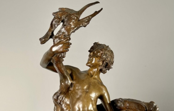 Alt text: Bronze sculpture of a boy wrestling a heron