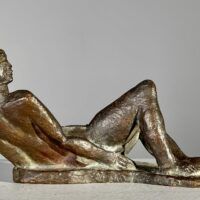 Alt text: Bronze sculpture of a reclining nude