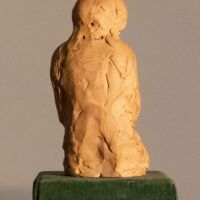 Alt text: Plaster sculpture of a kneeling girl