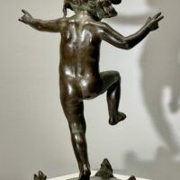 Alt text: Bronze sculpture of a skipping toddler