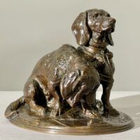 Alt text: Bronze sculpture of two dogs