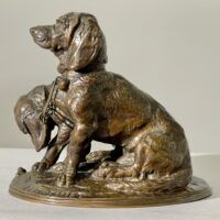 Alt text: Bronze sculpture of two dogs