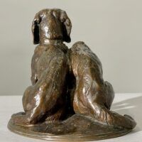 Alt text: Bronze sculpture of two dogs