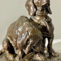 Alt text: Bronze sculpture of two dogs