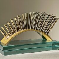 Alt text: metal sculpture with spikes on glass base