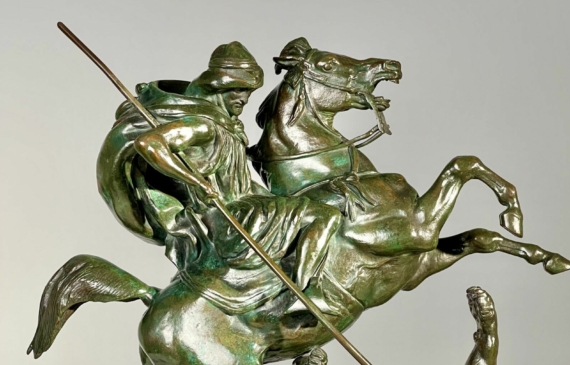 Alt text: Bronze sculpture of a horseman killing a lion