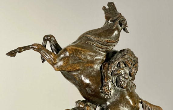 Alt text: Bronze sculpture of a lion attacking a horse