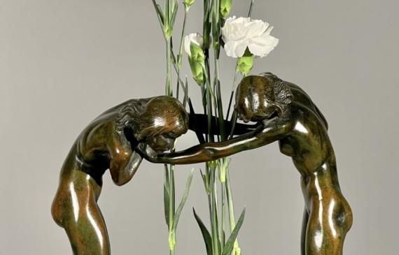 Alt text: Bronze sculpture of a horse and man drinking water