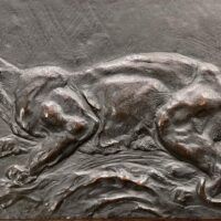 Alt text: Bronze relief of a panther