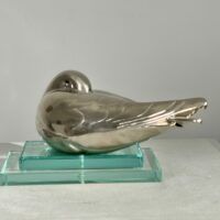 Alt text: metal sculpture of a sleeping bird